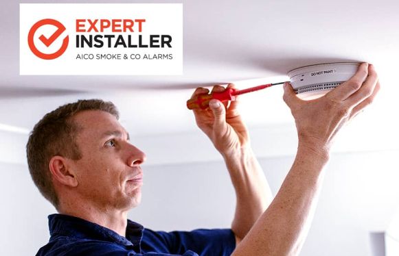 man fitting smoke alarm