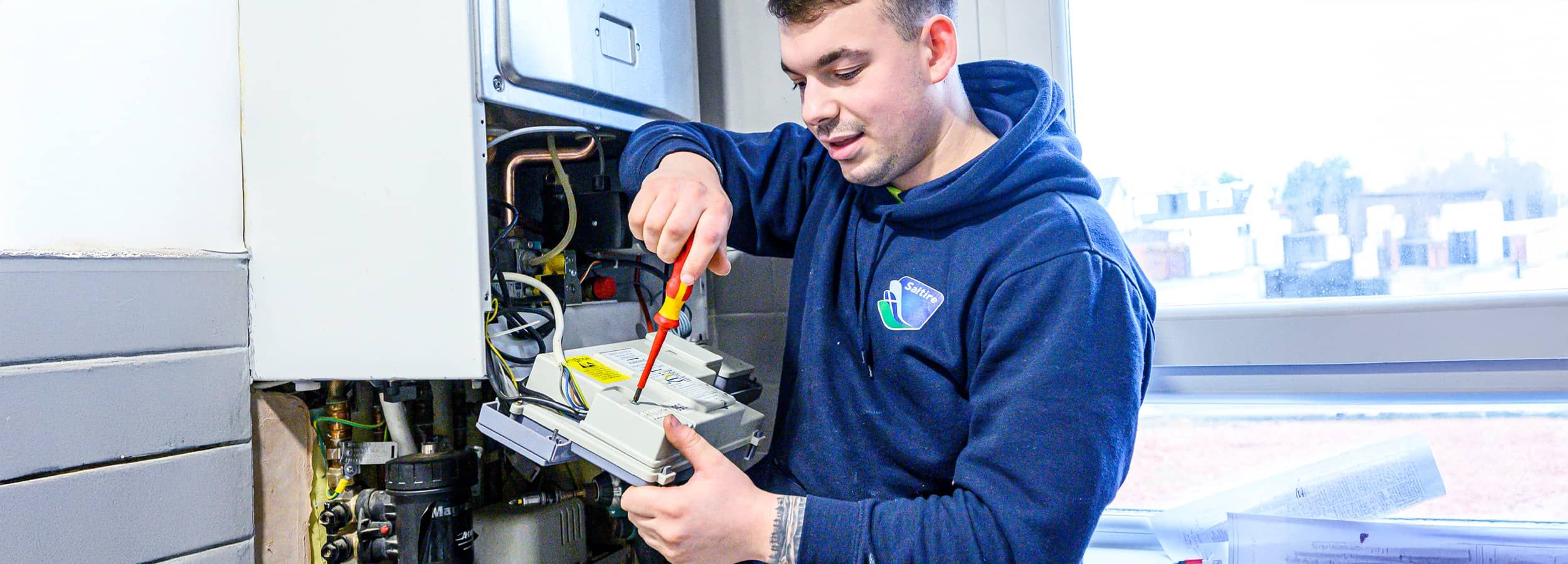 apprentice fixing boiler