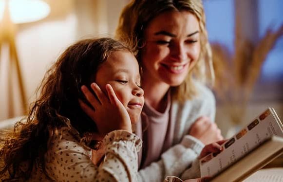 family keeping warm reading book