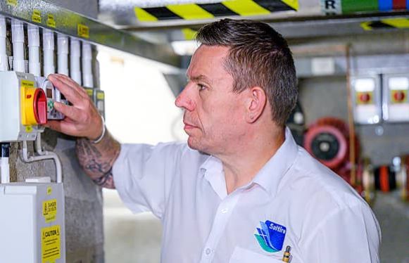 man inspecting the electrics